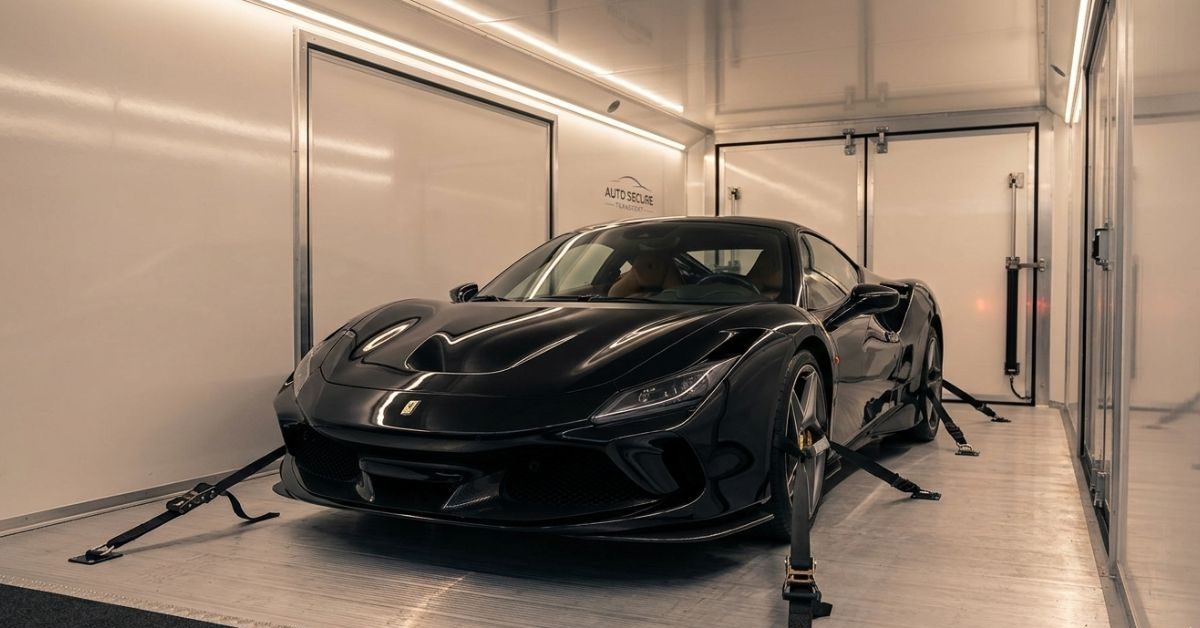 Luxury car inside enclosed transport trailer showing protected vehicle shipping insurance coverage. Luxury car inside enclosed transport trailer showing protected vehicle shipping insurance coverage.