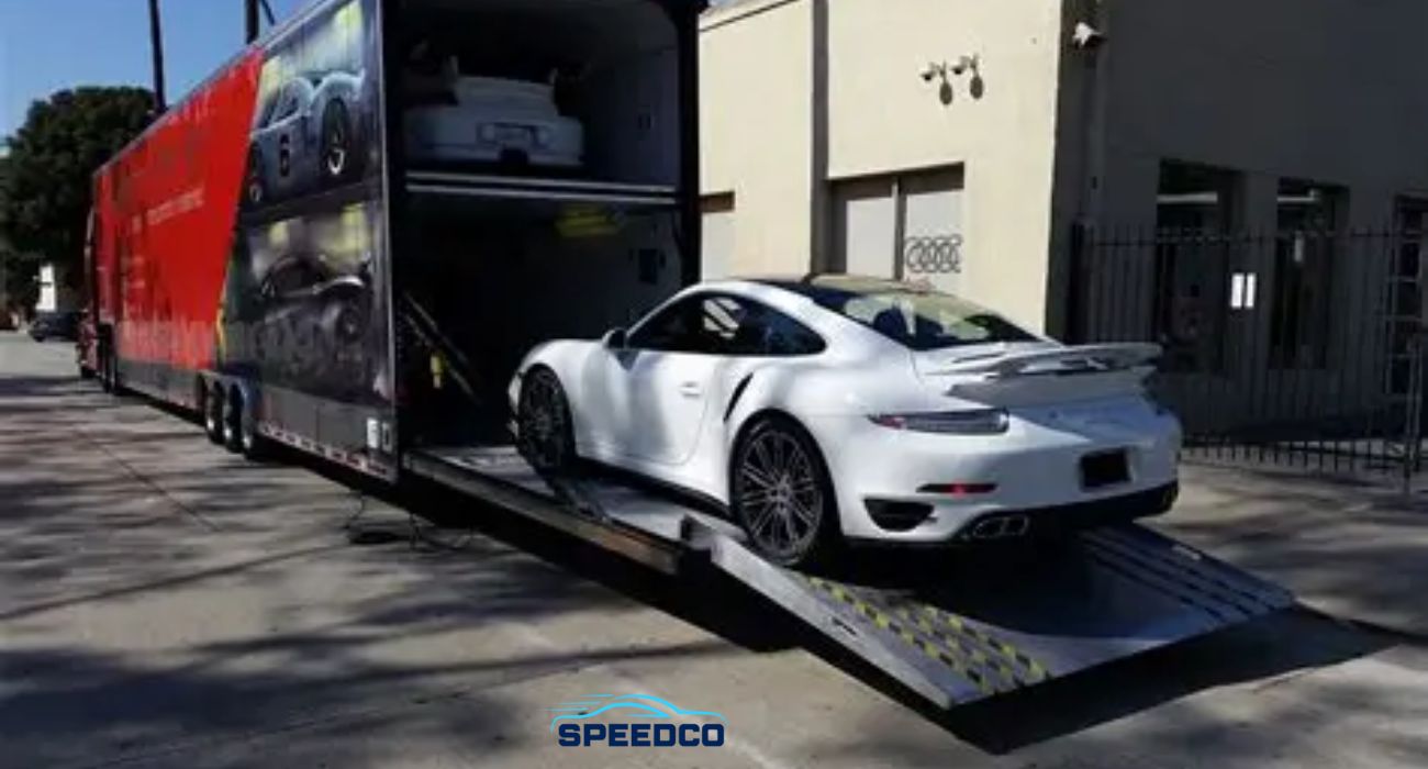 Luxury car, SUV, and motorcycle on auto transport trailer for specialty vehicle shipping